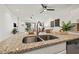 Close up of granite countertops, stainless steel sink, and view to the living room at 8078 Pine Crest St, Seminole, FL 33777