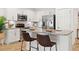 Bright kitchen features stainless steel appliances, granite countertops, and seating at the breakfast bar at 8078 Pine Crest St, Seminole, FL 33777