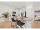 Kitchen island with stainless steel appliances, granite countertops, and white cabinets at 8078 Pine Crest St, Seminole, FL 33777