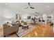 Inviting living room featuring hardwood floors, ceiling fan, neutral paint, and an open concept design at 8078 Pine Crest St, Seminole, FL 33777