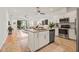 Open floor plan showing living room and kitchen with stainless steel appliances and island at 8078 Pine Crest St, Seminole, FL 33777