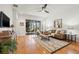 Inviting living room featuring hardwood floors, ceiling fan, neutral paint, and a sliding door to the lanai at 8078 Pine Crest St, Seminole, FL 33777