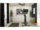Clean and spacious home gym featuring stationary bike, minimalist decor, and ample natural light at 8536 Bella Mar Trl, Parrish, FL 34219