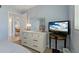 Bedroom with dresser and mirror and a television on a small round table at 870 Virginia St # 109, Dunedin, FL 34698