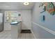 Interior condo entryway with bright natural light, decorative wall art, and a view into the kitchen area at 870 Virginia St # 109, Dunedin, FL 34698
