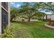 Expansive green lawn with mature trees leads to the community pool area at 870 Virginia St # 109, Dunedin, FL 34698