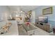 Comfortable living room with ample seating, stylish decor, and a view into the dining area at 870 Virginia St # 109, Dunedin, FL 34698