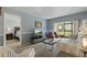 Inviting living room featuring neutral tones, a view to the screened in patio, and stylish furniture at 870 Virginia St # 109, Dunedin, FL 34698