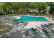 Aerial view of the community pool featuring a hot tub and plenty of lounge seating at 870 Virginia St # 109, Dunedin, FL 34698