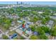An aerial view showcasing the property's location within a vibrant city neighborhood, surrounded by lush trees and city skyline at 1030 11Th S Ave, St Petersburg, FL 33705