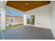Covered back porch with a view of the backyard, chain link fence and an adjacent house at 1030 11Th S Ave, St Petersburg, FL 33705