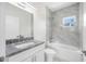 Charming bathroom showcasing a combined tub and shower, granite countertop, and modern fixtures at 1030 11Th S Ave, St Petersburg, FL 33705