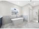Bright bathroom features a luxurious soaking tub with elegant tile accents and a serene atmosphere at 1030 11Th S Ave, St Petersburg, FL 33705