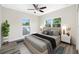 Modern bedroom with a large bed, two windows with a view, and stylish decor at 1030 11Th S Ave, St Petersburg, FL 33705