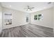Spacious bedroom features a ceiling fan, hardwood floors, and bright natural light from two windows at 1030 11Th S Ave, St Petersburg, FL 33705