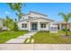 Inviting two-story home featuring a modern design, complemented by a beautifully landscaped front yard and a striking blue double door at 1030 11Th S Ave, St Petersburg, FL 33705