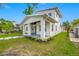 Charming two-story home with a welcoming front porch, neat landscaping, and a freshly manicured lawn, perfect for Gathering living at 1030 11Th S Ave, St Petersburg, FL 33705