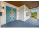 This home boasts a charming covered front porch, a striking blue double door, and modern lighting at 1030 11Th S Ave, St Petersburg, FL 33705