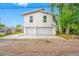 Modern two-story home featuring a three-car garage and a clean, contemporary design with white exterior and a well-lit driveway at 1030 11Th S Ave, St Petersburg, FL 33705