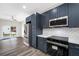 Modern kitchen featuring gray cabinets, stainless steel appliances, quartz countertops, and a decorative backsplash at 1030 11Th S Ave, St Petersburg, FL 33705