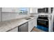 Modern kitchen with stainless steel appliances, granite counters, and a window at 1030 11Th S Ave, St Petersburg, FL 33705