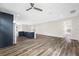 Open-concept kitchen and living space, featuring gray wood floors, modern cabinetry, stainless steel appliances, and a large island at 1030 11Th S Ave, St Petersburg, FL 33705