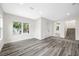 Bright open concept living room boasts gray wood floors and natural light at 1030 11Th S Ave, St Petersburg, FL 33705