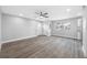 Spacious living area featuring gray walls, stylish ceiling fan, and a window view at 1030 11Th S Ave, St Petersburg, FL 33705