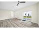 Open living area with sliding glass doors leading to the backyard and modern wood-look floors at 1030 11Th S Ave, St Petersburg, FL 33705