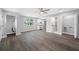 Open-concept living space with wood-look flooring, white cabinets, and stainless steel appliances at 1030 11Th S Ave, St Petersburg, FL 33705