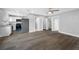 Spacious living space with wood-look flooring, kitchen, and multiple doorways at 1030 11Th S Ave, St Petersburg, FL 33705
