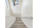 Staircase with wood-look steps and white walls, leading to upper level at 1030 11Th S Ave, St Petersburg, FL 33705