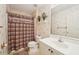 Cozy bathroom featuring decorative wallpaper, patterned shower curtain, and neutral flooring at 10530 Maronda Dr, Riverview, FL 33569
