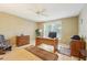 Bedroom featuring a ceiling fan, window with blinds, and classic wood furniture at 10530 Maronda Dr, Riverview, FL 33569
