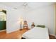 Bright bedroom with hardwood floors, decorated with a ceiling fan and matching wood furniture at 10530 Maronda Dr, Riverview, FL 33569
