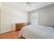Bedroom featuring a dresser, ceiling fan, window with shutters, and hardwood flooring at 10530 Maronda Dr, Riverview, FL 33569
