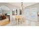 Bright breakfast nook featuring a table, decorative lighting, and access to the outdoors via French doors at 10530 Maronda Dr, Riverview, FL 33569