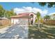 Charming two-story home with a well-maintained lawn, mature trees, and a two car garage at 10530 Maronda Dr, Riverview, FL 33569