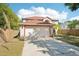 Charming two-story home with a well-maintained lawn, mature trees, and a two car garage at 10530 Maronda Dr, Riverview, FL 33569