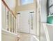 Bright foyer with tile flooring, staircase, large windows, and a white front door at 10530 Maronda Dr, Riverview, FL 33569