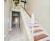 Inviting foyer with staircase, tiled floor, and arched doorway with views to the dining room at 10530 Maronda Dr, Riverview, FL 33569