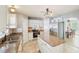 Well-lit kitchen featuring a central island, stainless steel appliances, and ample cabinet space at 10530 Maronda Dr, Riverview, FL 33569