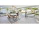 Screened in patio with dining set overlooking a sparkling swimming pool and lush backyard at 10530 Maronda Dr, Riverview, FL 33569