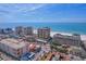Stunning aerial view showcasing the beachfront condos, commercial spaces, and bustling beach activity at 11 Baymont St # 1109, Clearwater Beach, FL 33767
