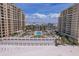 Aerial view of luxurious beachfront condos, pool, and immaculate sandy beach at 11 Baymont St # 1109, Clearwater Beach, FL 33767