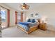 Bright bedroom featuring a ceiling fan, soft carpet, and access to a private balcony at 11 Baymont St # 1109, Clearwater Beach, FL 33767