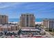 Impressive exterior view of a modern beachfront condo complex with ocean views and palm trees at 11 Baymont St # 1109, Clearwater Beach, FL 33767