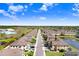 Aerial view of a well-planned neighborhood with lush landscaping and serene ponds at 11521 Crowned Sparrow Ln, Tampa, FL 33626