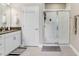 Bright bathroom featuring a granite-topped vanity, glass shower enclosure, and modern fixtures at 11521 Crowned Sparrow Ln, Tampa, FL 33626