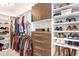 Organized walk-in closet with custom shelving, drawers, and ample hanging space for clothes and accessories at 11521 Crowned Sparrow Ln, Tampa, FL 33626